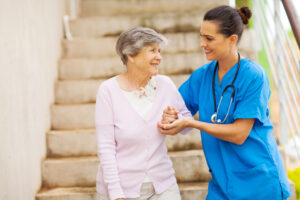 Legal Options In Nursing Home Abuse Cases - caregiver helping senior woman walking down stairs